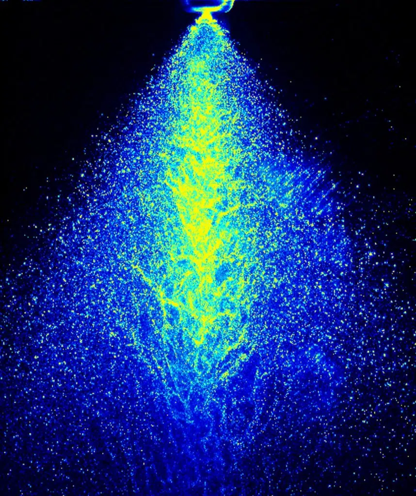 High-resolution laser imaging of liquid spray pattern captured with LaVision GmbH’s Laser Imaging System (LIS), showing fluid dynamics and droplet distribution in blue and yellow.